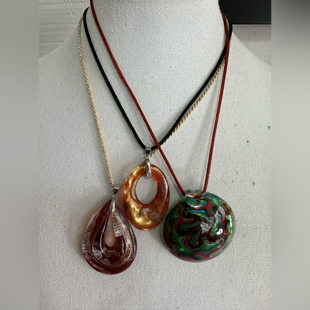Three unique styles of glass necklaces on satin cord
